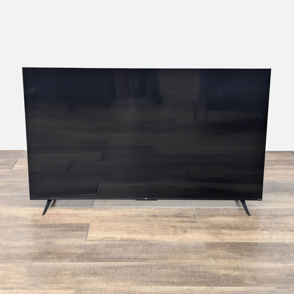 the black glass tv stand is a modern design.