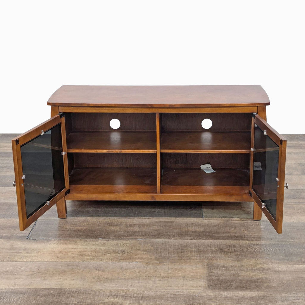 a mid century modern walnut and glass entertainment center with a glass door.