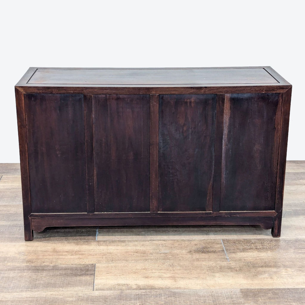 a dark wood cabinet with a large central panel.