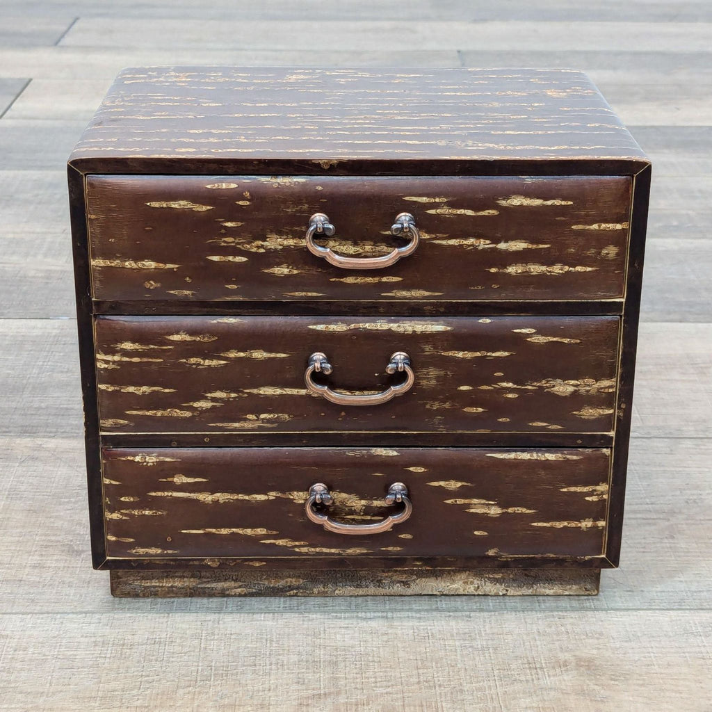 a small wooden chest with three drawers.