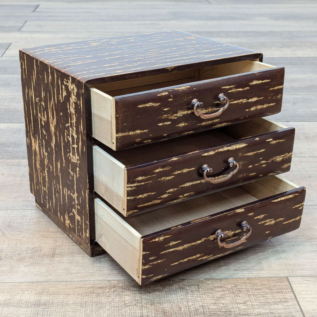 a vintage wooden three drawer chest with a distressed finish.