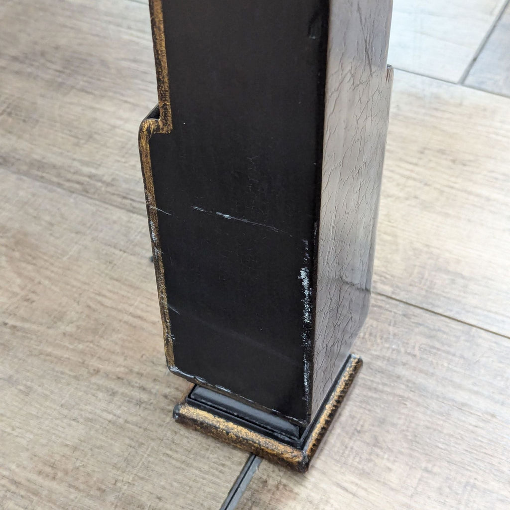 a pair of antique black wood and metal table legs