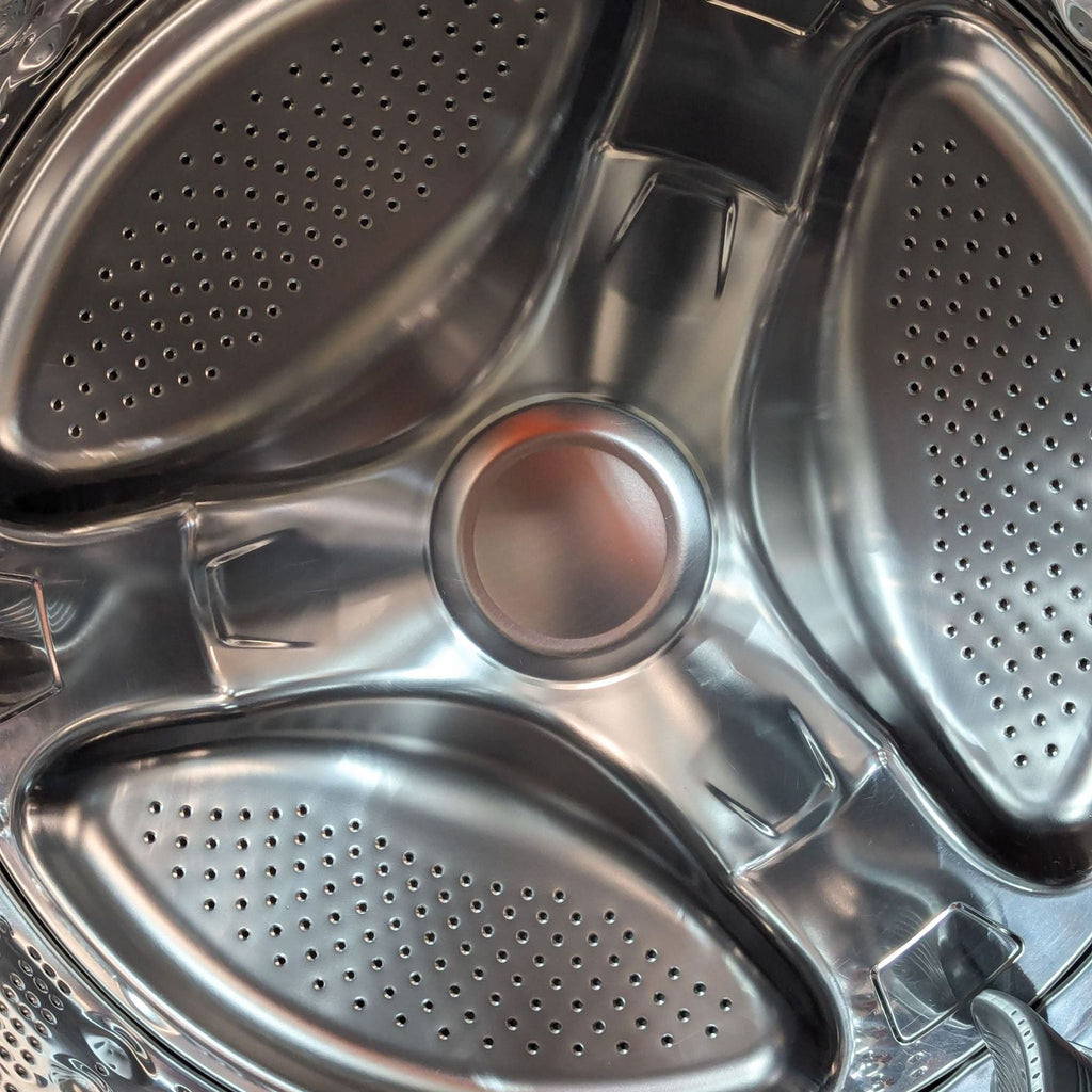 a close up of a washing machine with a metal rim.