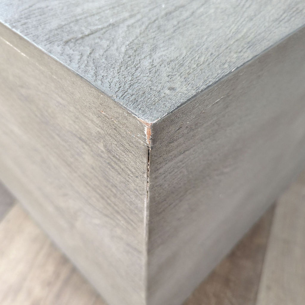 a close up of the wood grained base of a wooden cube.