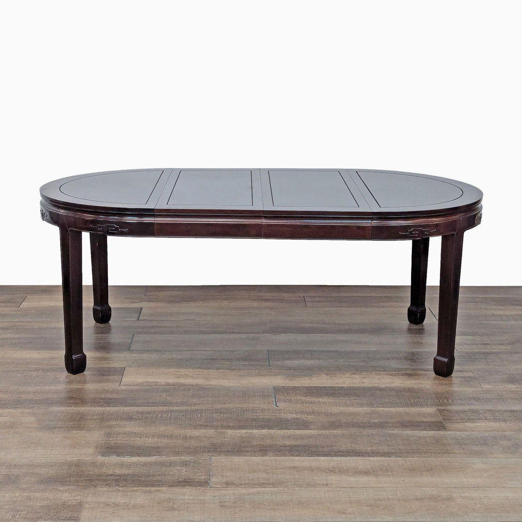 a chinese coffee table with a dark wood top and a dark wood top.