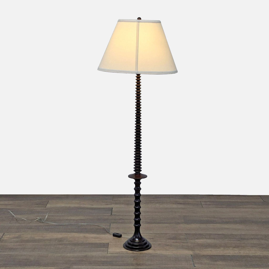 a black and white table lamp with a white shade.