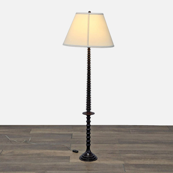 a black and white table lamp with a white shade.