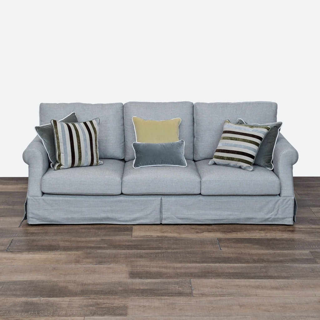 a sofa with pillows on a wooden floor. 3d rendering