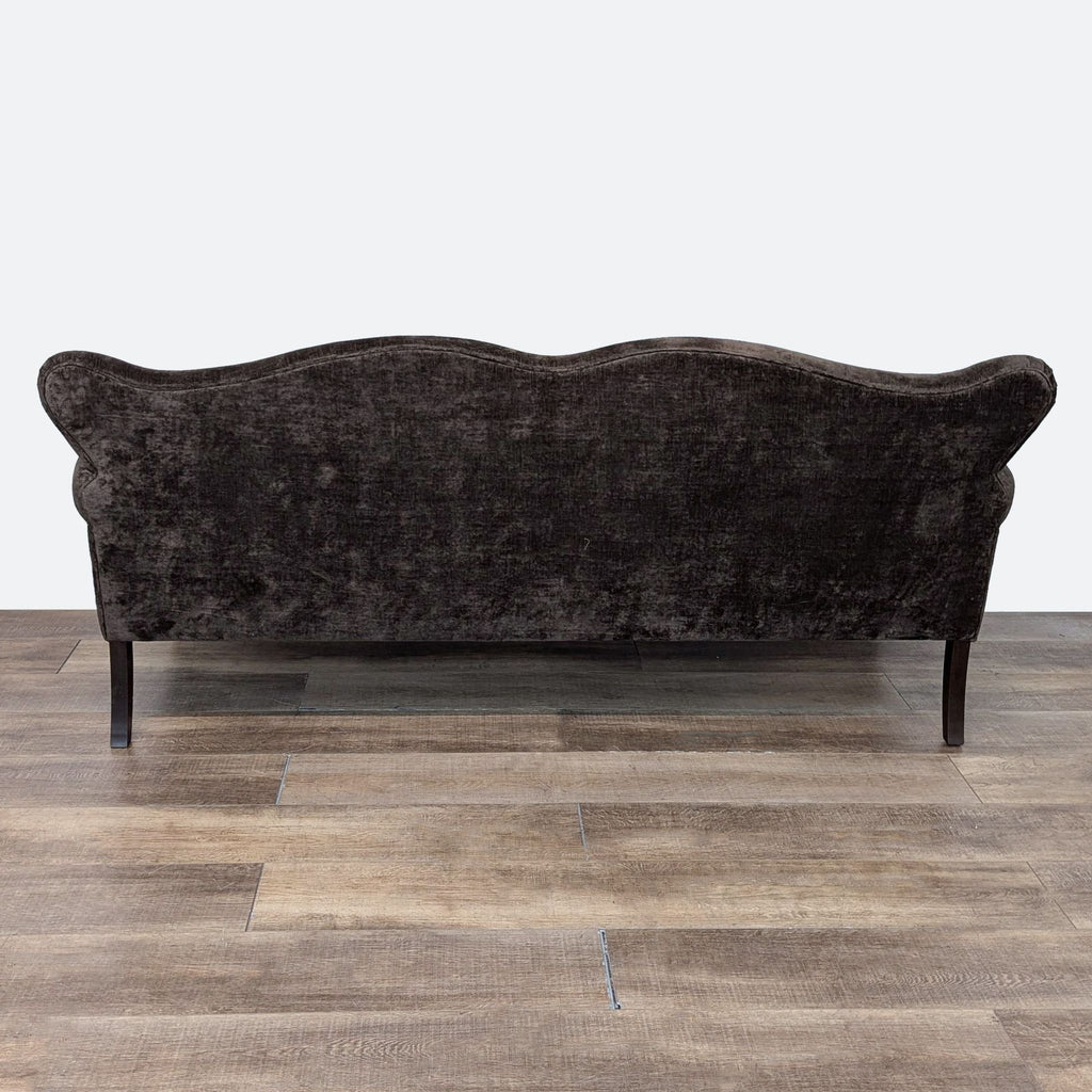 a vintage sofa in a dark velvet fabric