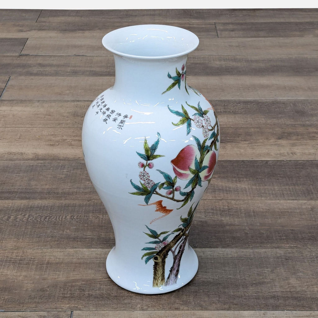 a white vase with flowers on a wooden floor 