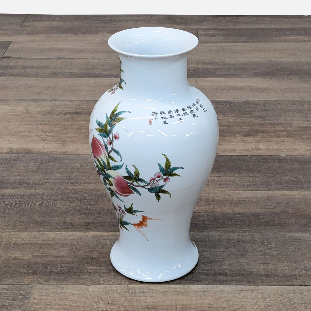 a white vase with flowers on a wooden floor 