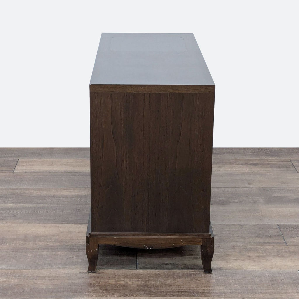 a mid century modern walnut desk with a black top.