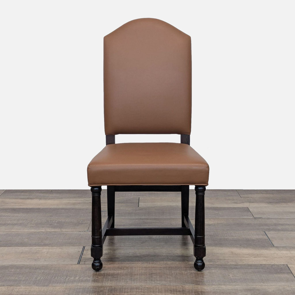 a pair of chairs with a brown leather upholstered back and legs.