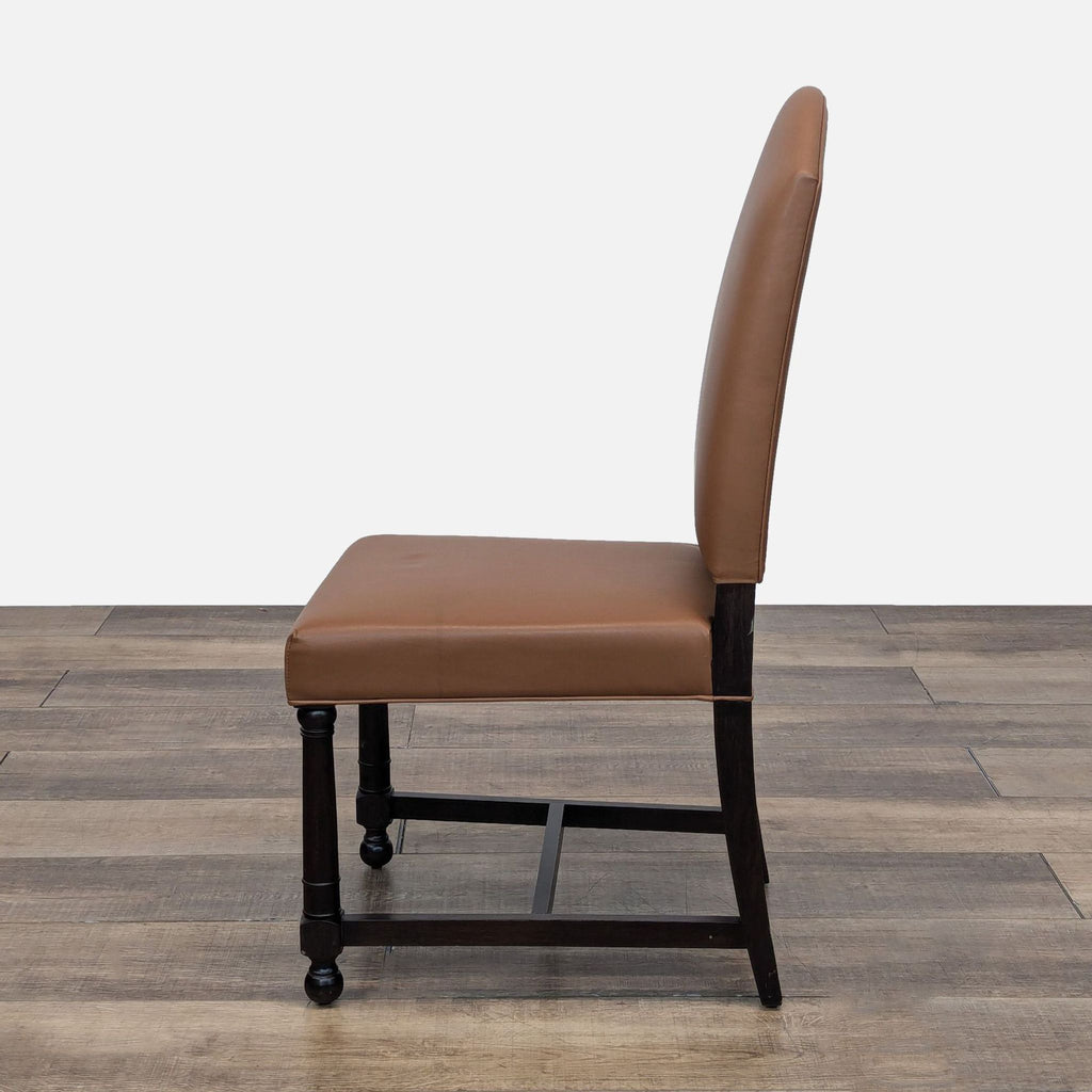 a brown leather dining chair with a black frame and a black frame.