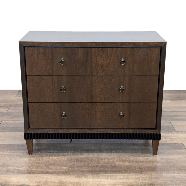 a mid century modern, dark brown wood chest of drawers with four drawers.