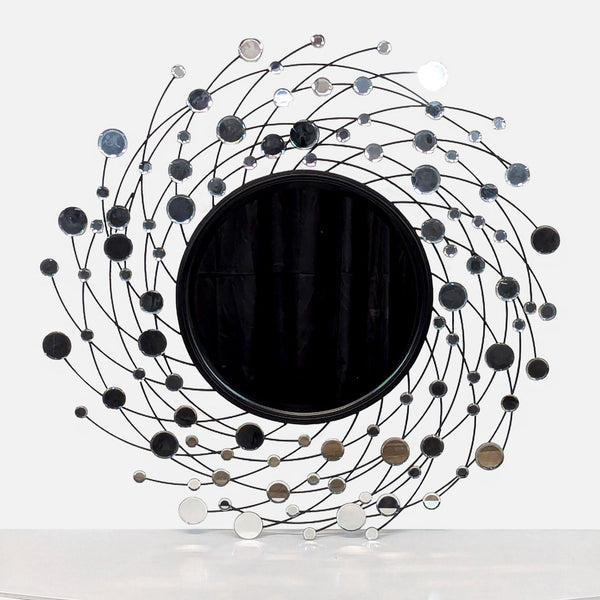 a large metal sculpture of a circle with a black circle in the center.