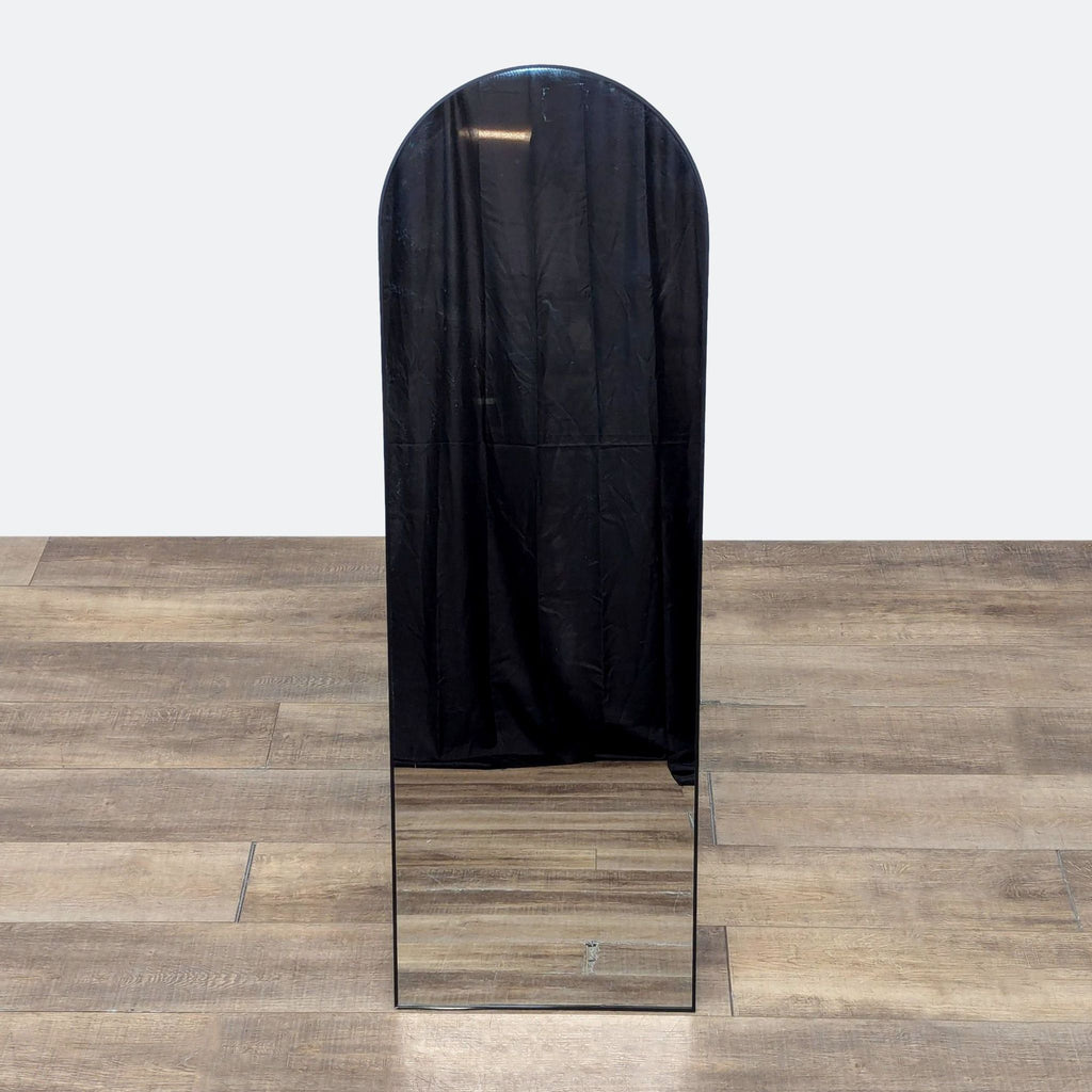 a mirror with a black cloth over it.