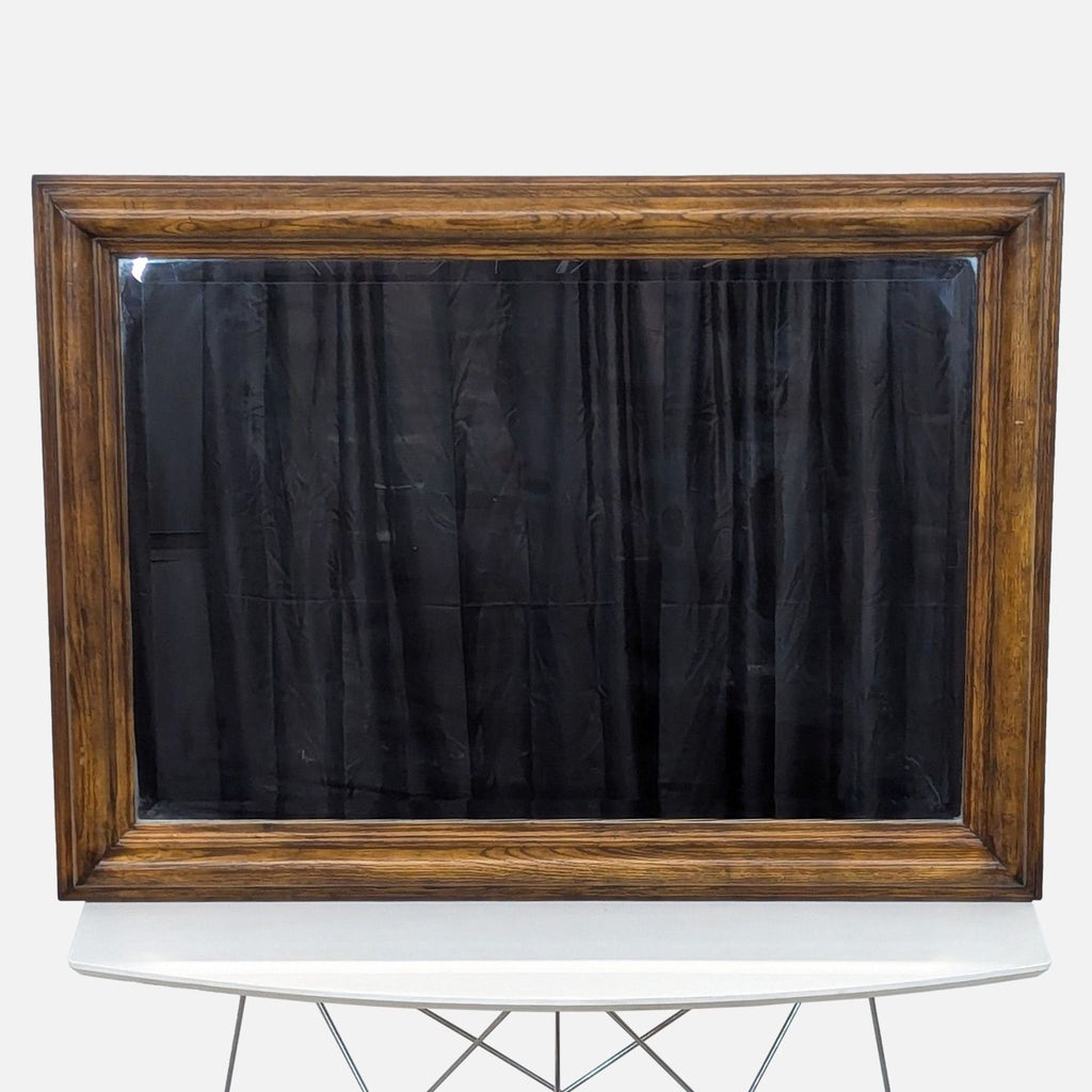 a framed mirror with black fabric.