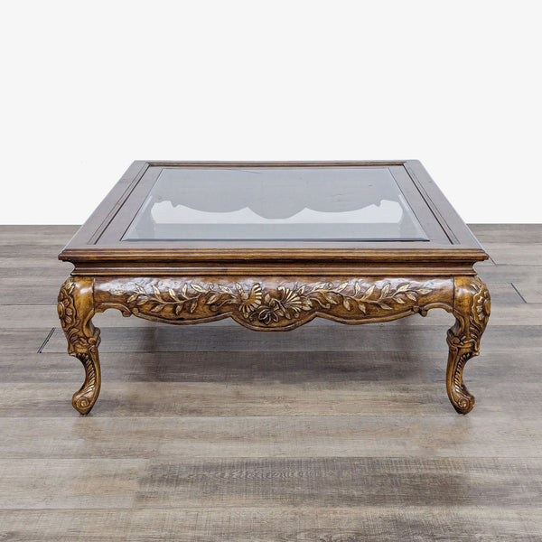 a 19th century french carved wood coffee table with glass top.