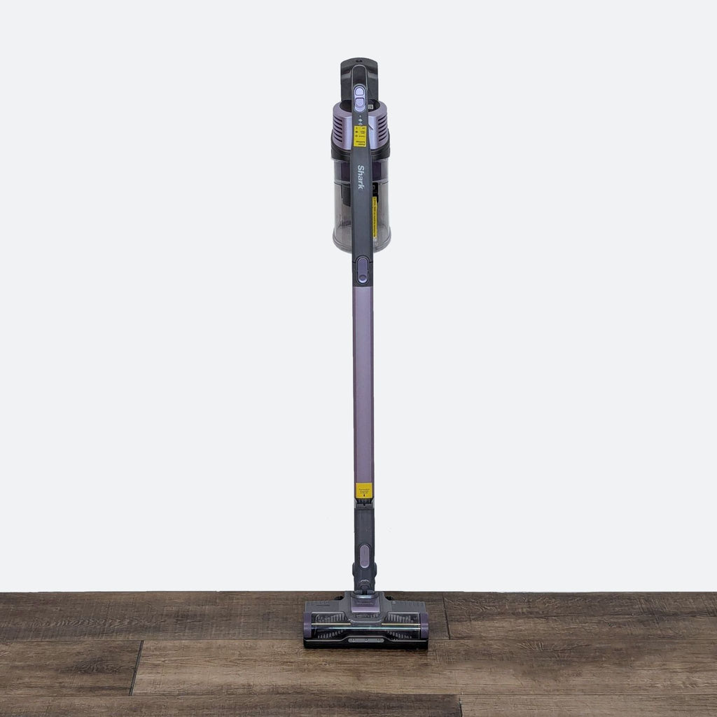 a purple floor cleaner on a wooden floor.