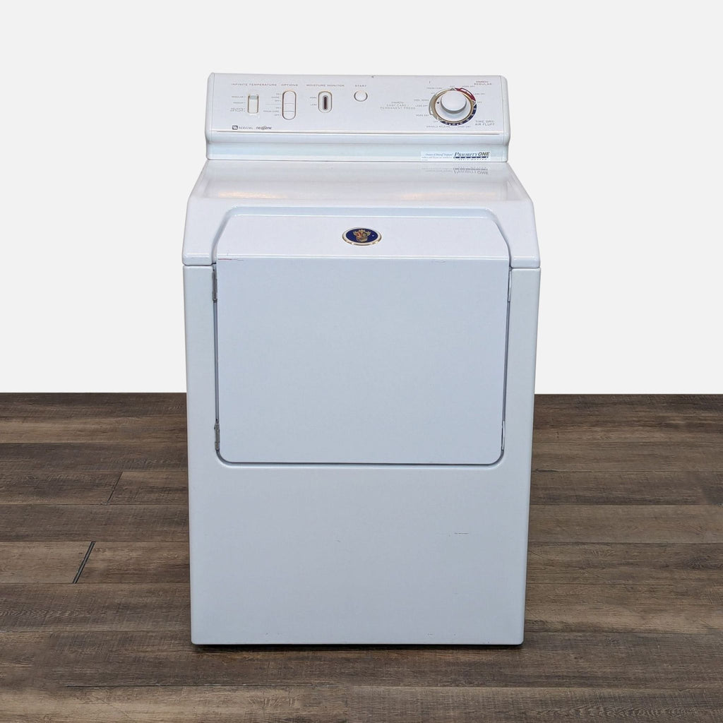 a washing machine on a wooden floor.