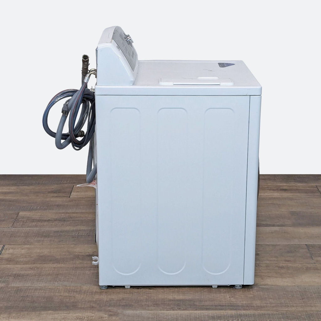 a white refrigerator sitting on top of a wooden floor 