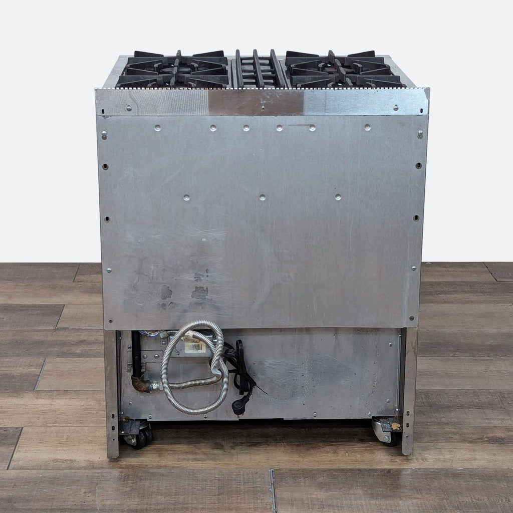 a large stainless steel gas stove with wheels.