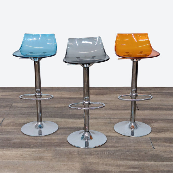 a set of four chrome and glass bar stools