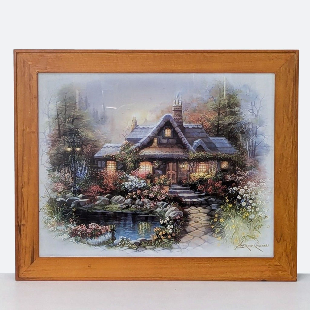 framed oil painting of a cottage by a pond