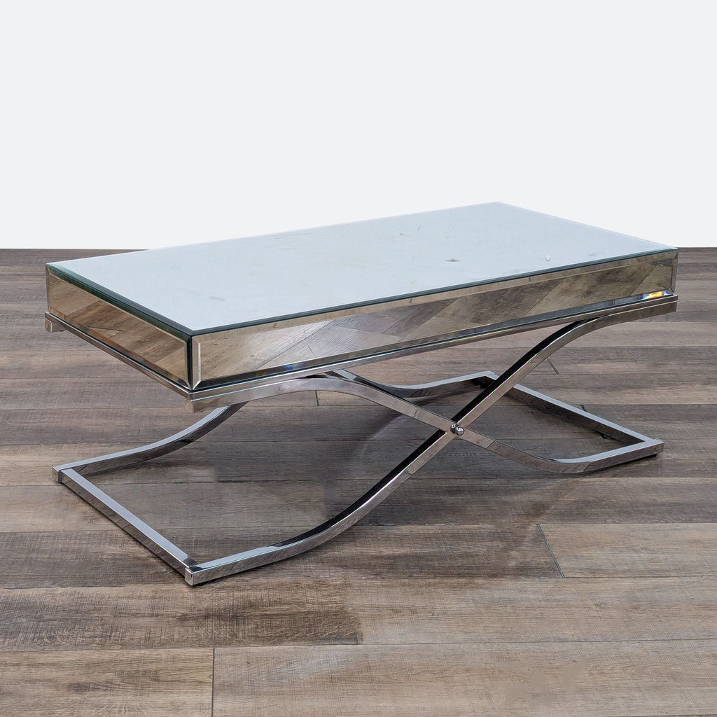 a chrome coffee table with a mirrored base.