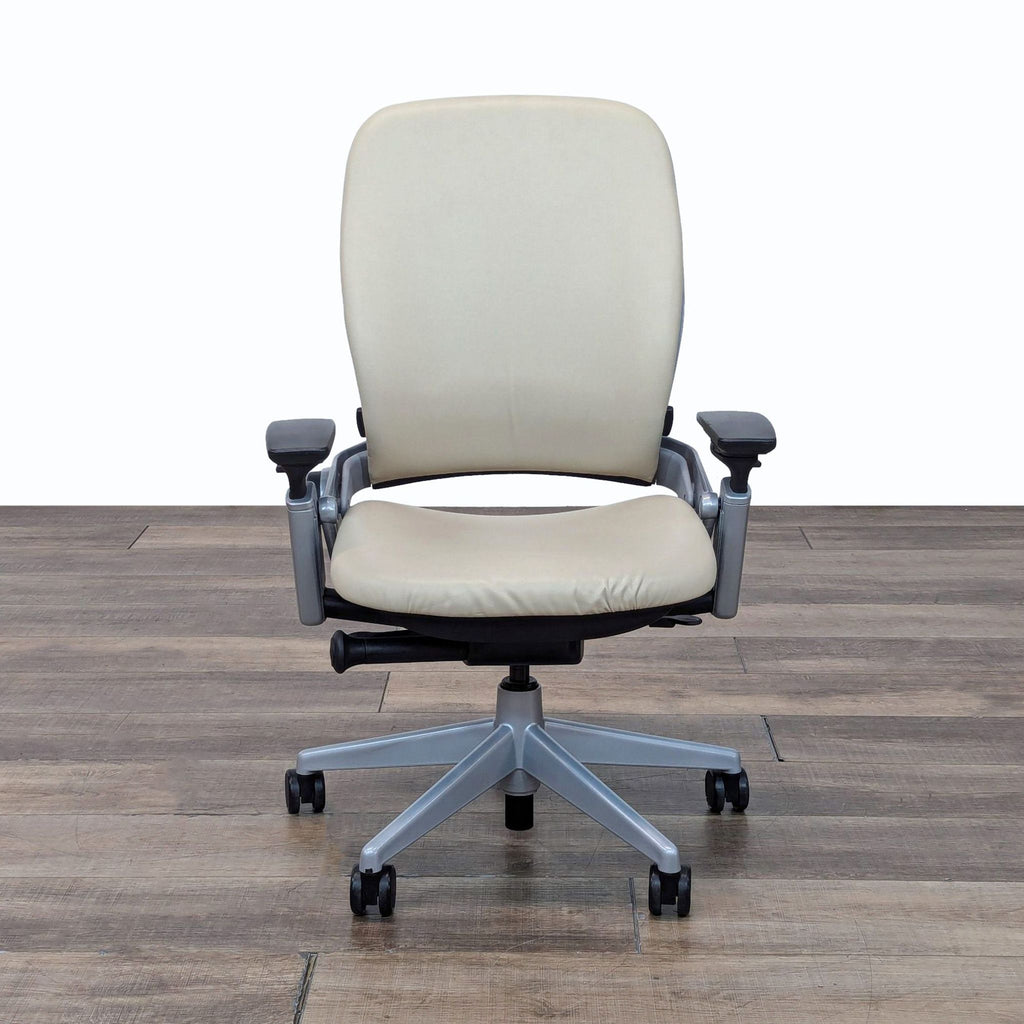 a white leather office chair with a beige seat and arms.