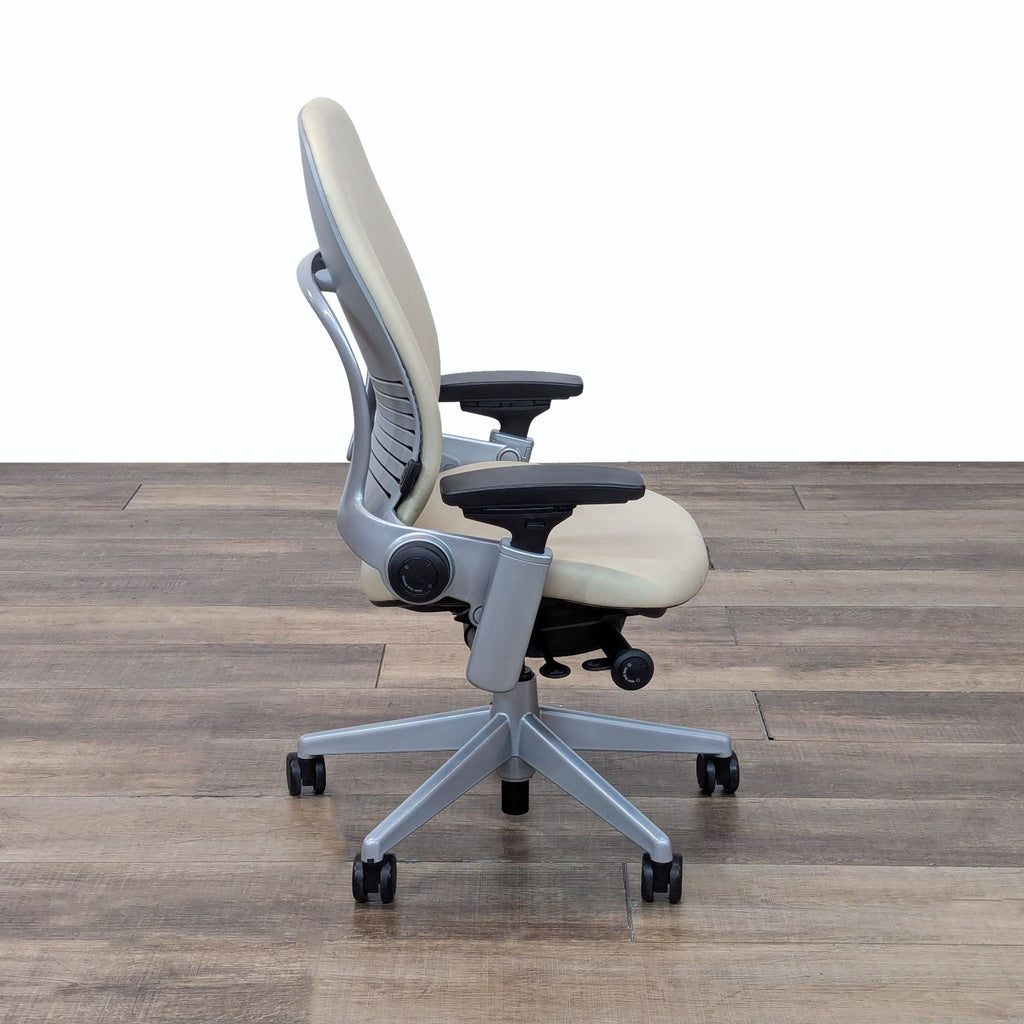 the [ unused0 ] chair in beige with black arms and arms