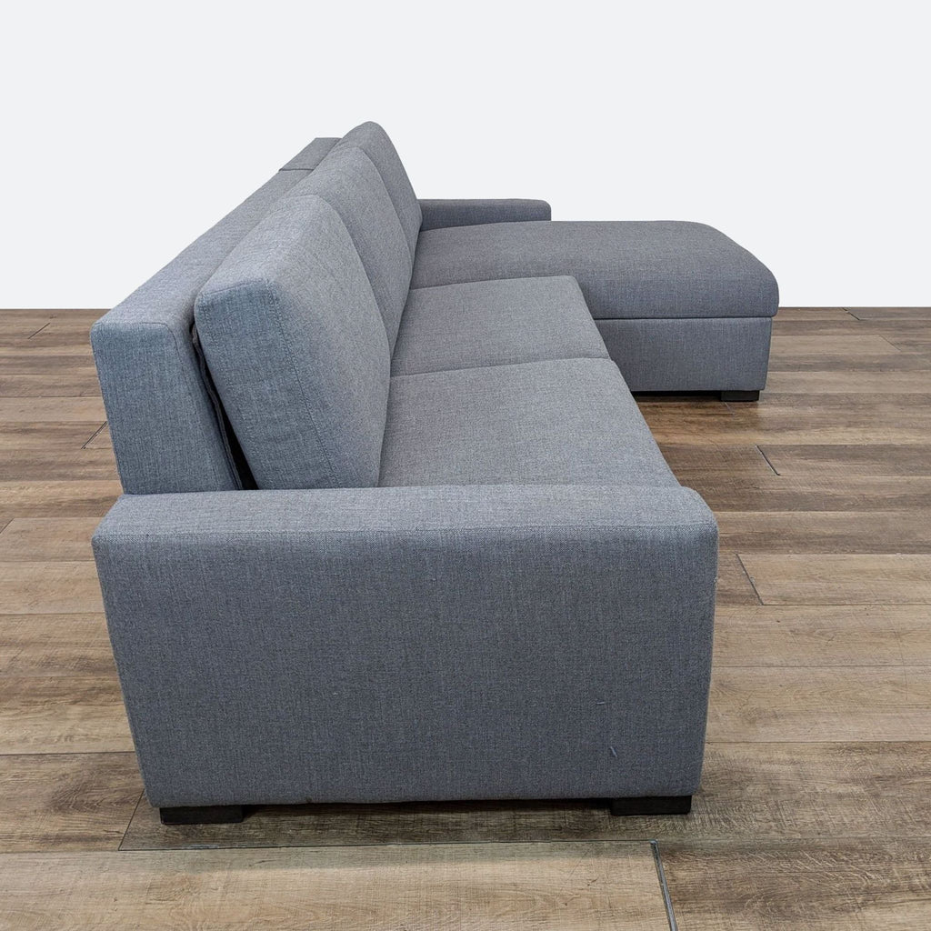 sofa is a modern design that is made of soft grey fabric. the sofa is made of a