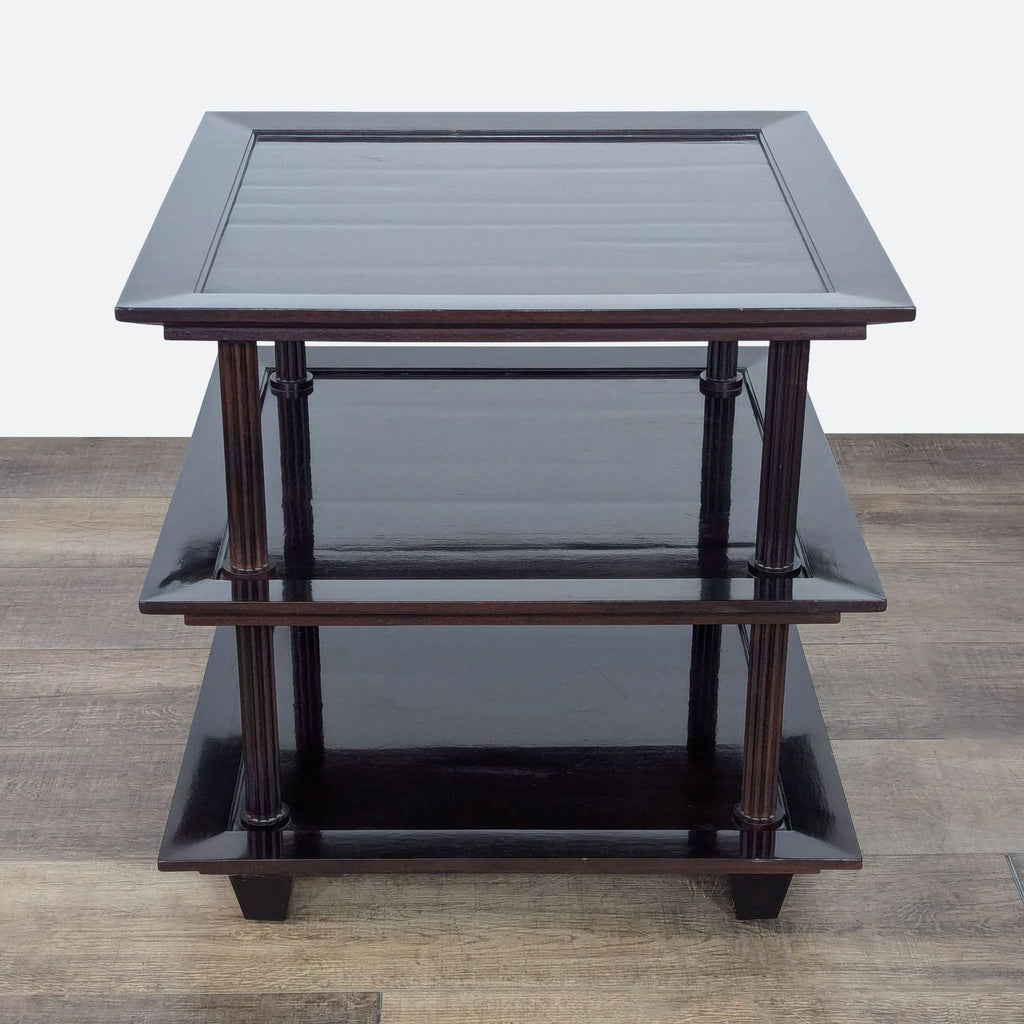 a set of three square tables with a dark wood finish.