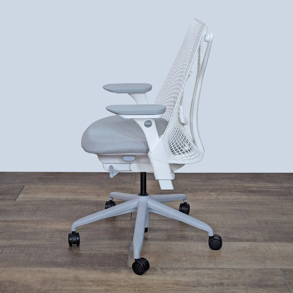 the [ unused0 ] chair is a white mesh chair with a white back and arms.