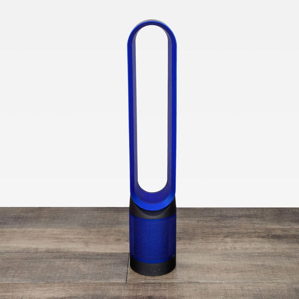 a blue and white vase sitting on a wooden table 