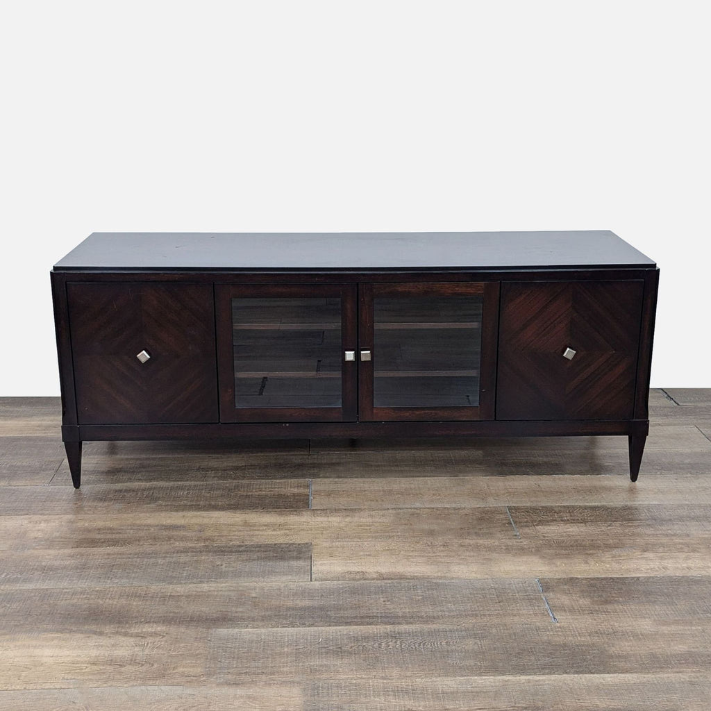 a mid century modern black walnut sideboard with two doors and a glass door.