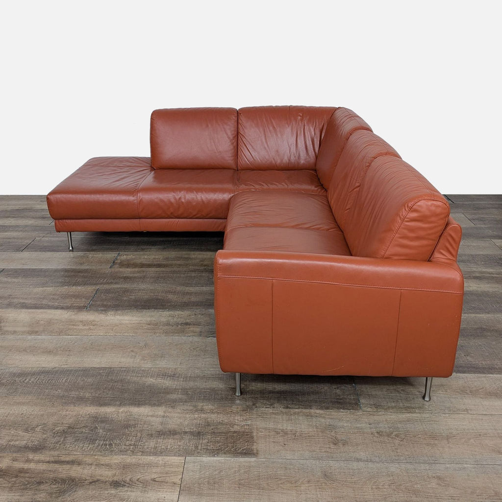 a pair of leather sofas in brown leather