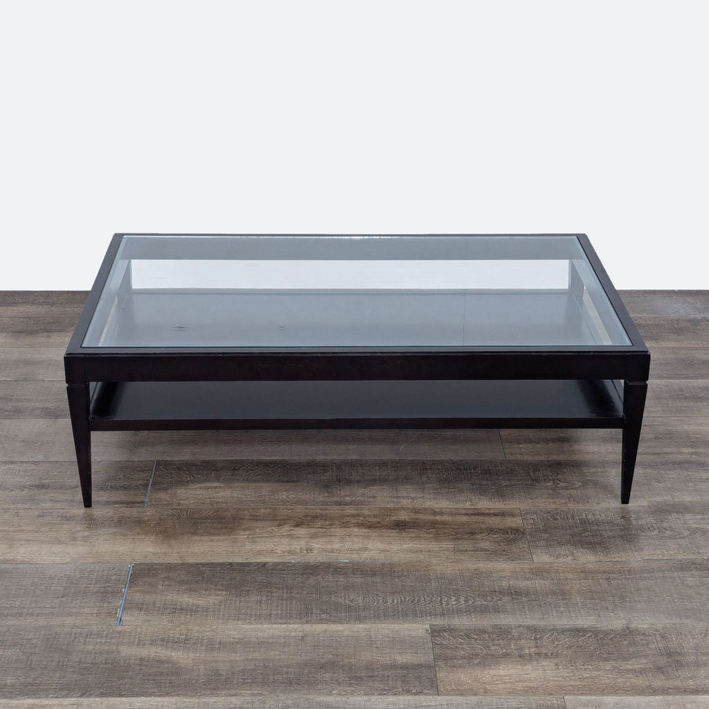 the coffee table is made from a black lacquered steel frame with a glass top.