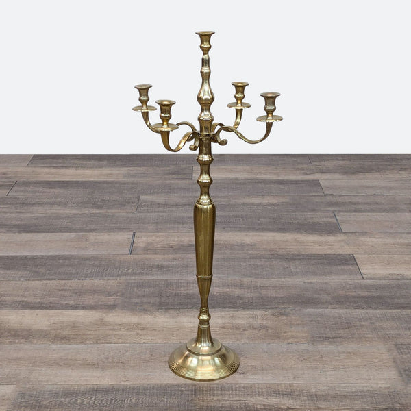 a brass candelabra with three candlesticks