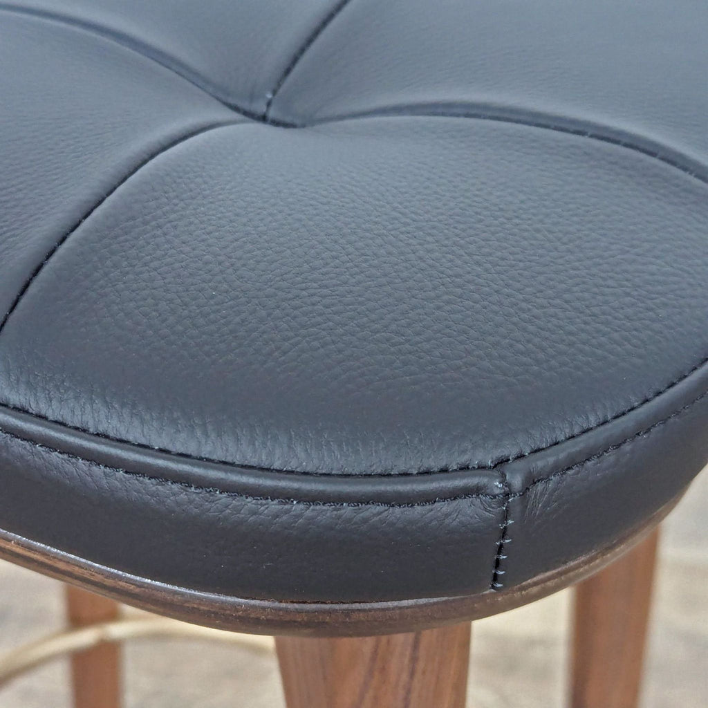 a black leather chair with a black leather seat 