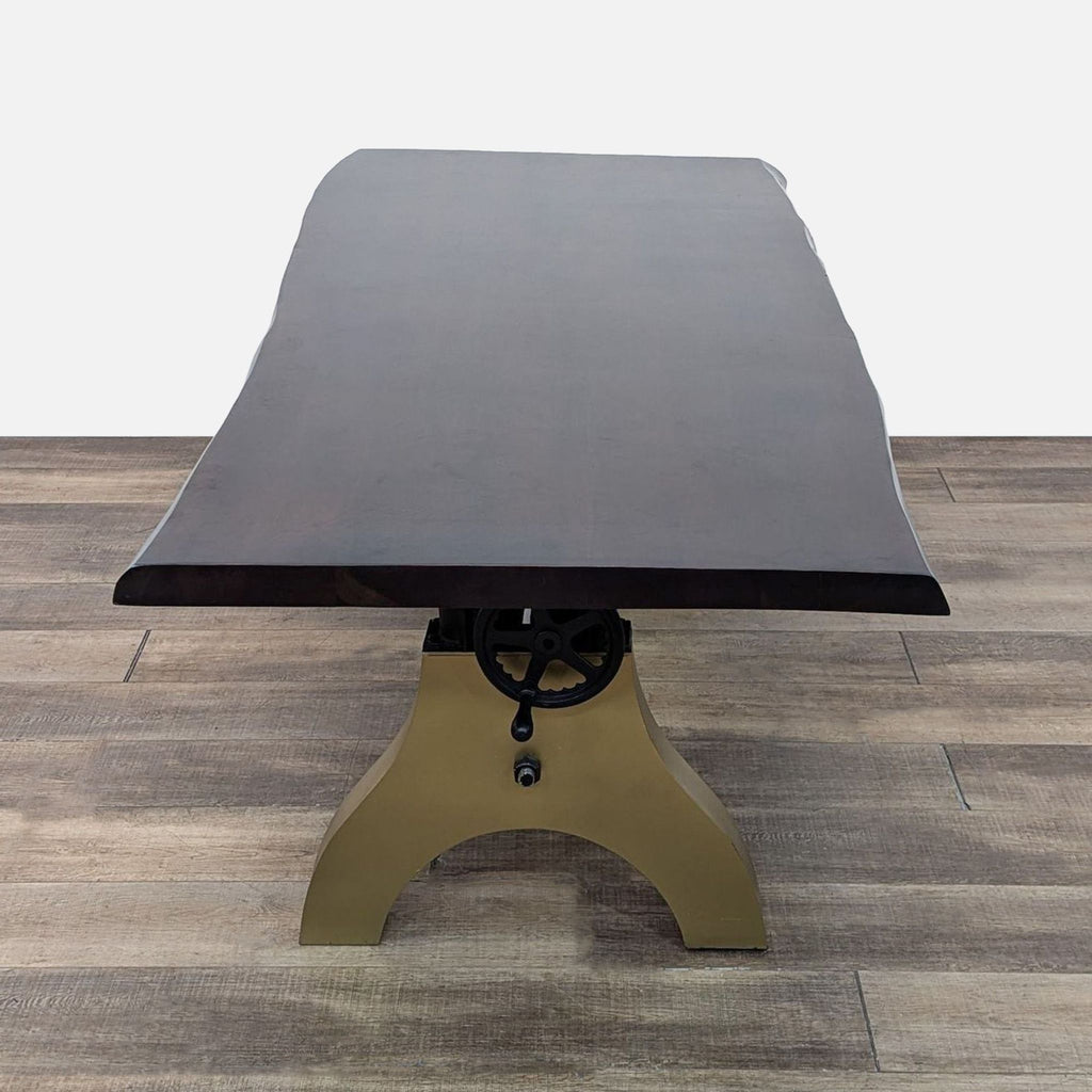 a large, black and brass table with a black leather top.