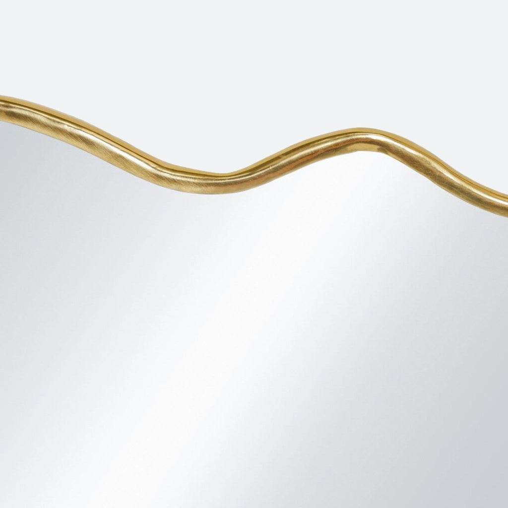 a gold and white wavy line on a mirror