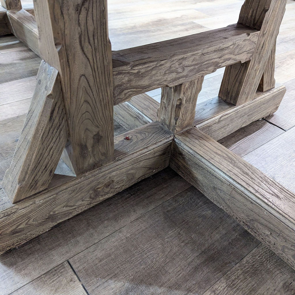 a wooden bench sitting on top of a wooden floor 