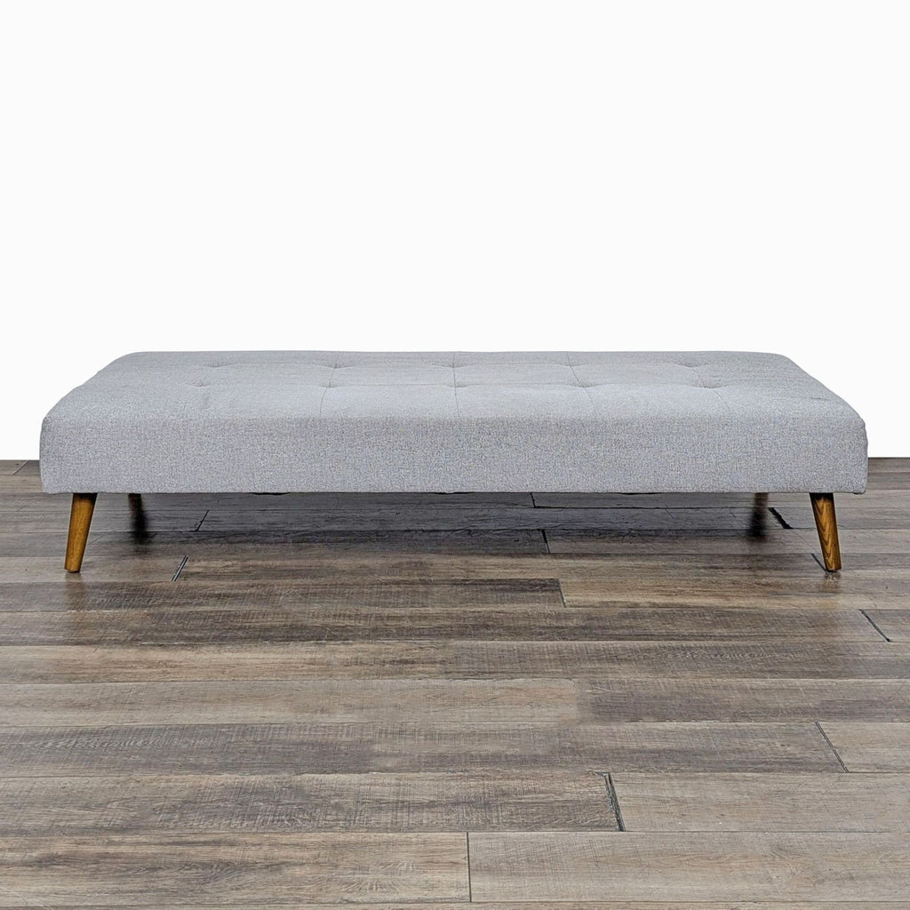 a wooden bench sitting on top of a floor 