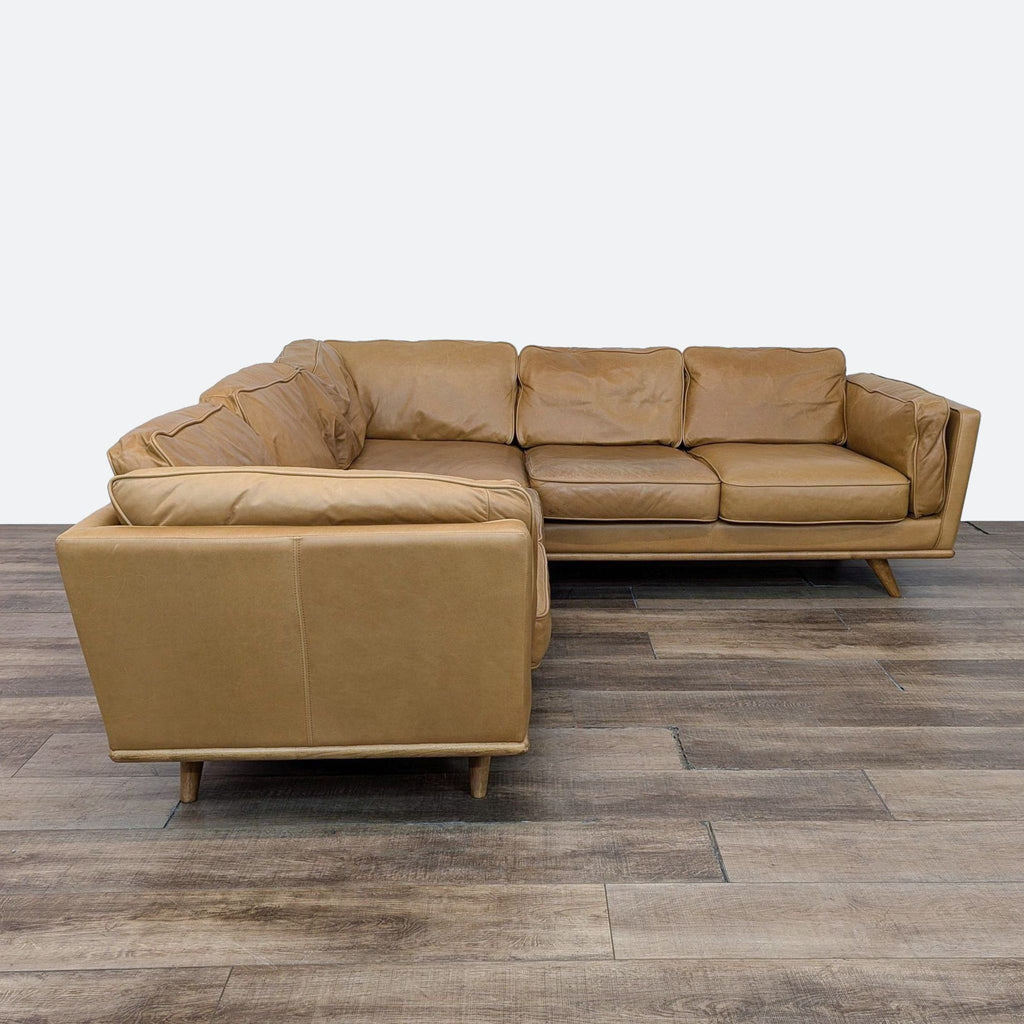 a couch with a brown leather couch in a room 