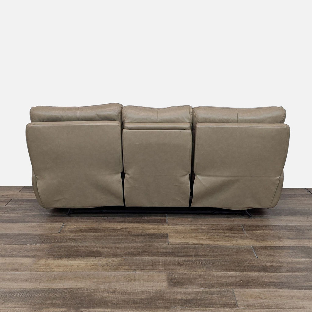 a black leather couch with a black leather cushion 