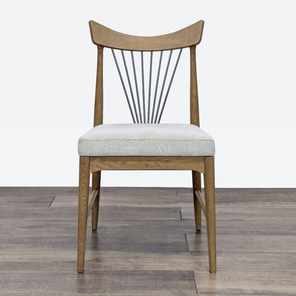 a wooden chair sitting on top of a wooden floor 