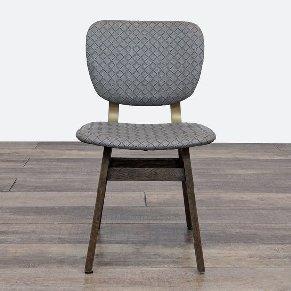 Quilted grey faux leather dining chair with brass supports and honey oak legs by Four Hands.  