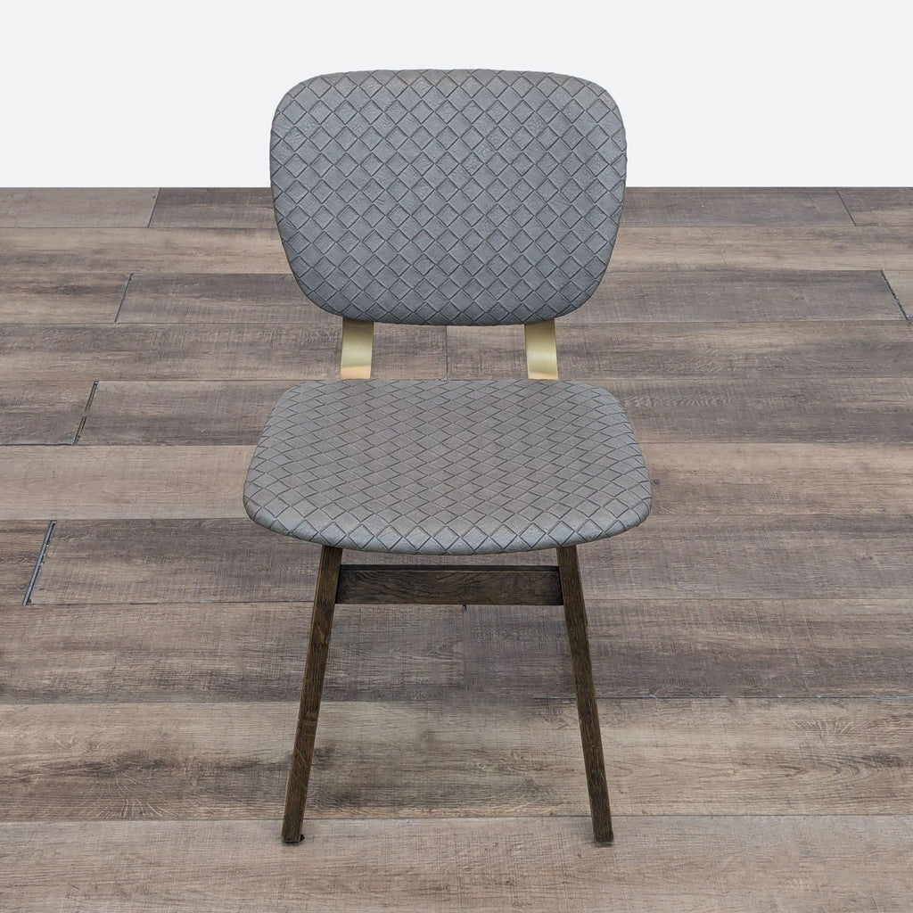 Embossed grey faux leather Four Hands dining chair, featuring honey oak legs and brass accents.  
